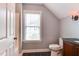 Bathroom featuring a dark countertop vanity and sconce lighting with a neutral color scheme at 604 Mills St, Raleigh, NC 27608