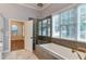 Bright bathroom featuring a tub, shower, and tile flooring at 604 Mills St, Raleigh, NC 27608