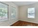 Bright bedroom with hardwood floors and natural light from multiple windows at 604 Mills St, Raleigh, NC 27608