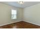 Clean bedroom featuring hardwood floors and neutral paint at 604 Mills St, Raleigh, NC 27608