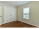 This bedroom offers hardwood floors, a window and a closet with double doors at 604 Mills St, Raleigh, NC 27608