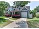 Charming front exterior features manicured landscaping, front porch, and a garage at 604 Mills St, Raleigh, NC 27608