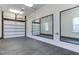Spacious garage featuring a concrete floor, bright lighting, and large mirrors for a workout space at 604 Mills St, Raleigh, NC 27608