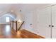 Hallway featuring hardwood floors, white trim, and access to multiple rooms at 604 Mills St, Raleigh, NC 27608