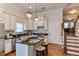 Elegant kitchen featuring white cabinetry, a center island, stainless steel appliances, and hardwood floors at 604 Mills St, Raleigh, NC 27608