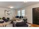 Cozy living room featuring a neutral sofa, elegant decor, and bright natural light from large windows at 604 Mills St, Raleigh, NC 27608