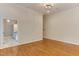 Open living room area with hardwood flooring, and adjacent kitchen space at 604 Mills St, Raleigh, NC 27608