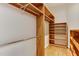 Well-organized walk-in closet with wooden shelving and hanging rods at 604 Mills St, Raleigh, NC 27608