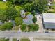 An aerial view of a home showcasing the backyard, mature trees and its proximity to surrounding buildings at 722 Baker St, Oxford, NC 27565