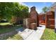 Backyard area featuring a large, brick outdoor grill and partially-enclosed patio with hot tub at 722 Baker St, Oxford, NC 27565