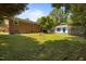 Spacious backyard featuring a brick home, detached garage, and lush green grass at 722 Baker St, Oxford, NC 27565