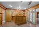 Home bar features wood paneling, tiled floors, storage, and adjacent access to an additional room and backyard via glass doors at 722 Baker St, Oxford, NC 27565