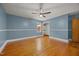 Large bedroom boasting hardwood floors, a ceiling fan, a window and a convenient closet at 722 Baker St, Oxford, NC 27565