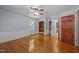 Bright bedroom features hardwood floors, ceiling fan, a closet, and access to other rooms at 722 Baker St, Oxford, NC 27565