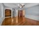 Bedroom features hardwood floors, ceiling fan, white wainscotting, a closet, and access to other rooms at 722 Baker St, Oxford, NC 27565