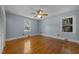 Light-filled bedroom with hardwood floors, ceiling fan, and two windows for ample natural light at 722 Baker St, Oxford, NC 27565