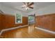 Dining room features hardwood floors, paneled walls, and large windows offering plenty of natural light at 722 Baker St, Oxford, NC 27565