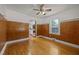 Dining room with hardwood floors, wood paneling, a ceiling fan, and large windows with views of the backyard at 722 Baker St, Oxford, NC 27565