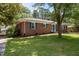 Charming brick home with blue shutters and door, complemented by a well-manicured lawn at 722 Baker St, Oxford, NC 27565