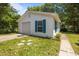 Exterior shot of a detached one-car garage with a white door and teal shutters at 722 Baker St, Oxford, NC 27565