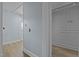 Hallway features light blue walls and beige wood-look floors with views of multiple rooms and doorways at 722 Baker St, Oxford, NC 27565