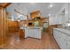 Large kitchen island features a gas cooktop, breakfast bar, and decorative range hood and ceramic tile floors at 722 Baker St, Oxford, NC 27565