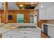 Kitchen island features a gas cooktop, breakfast bar, and decorative range hood. Custom wood accents throughout at 722 Baker St, Oxford, NC 27565