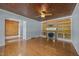 Living room with hardwood floors, wood-burning fireplace with built-in shelves, and access to an adjacent room at 722 Baker St, Oxford, NC 27565