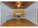 Bright living room features a brick fireplace, custom built-ins, and a decorative tin ceiling with ceiling fan at 722 Baker St, Oxford, NC 27565