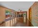 Bright living room with hardwood floors, brick accent wall, built-in bookshelves, ceiling fan, and access to deck through sliding glass doors at 722 Baker St, Oxford, NC 27565