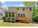 Exterior rear view of home shows a deck, manicured landscaping, and neutral siding at 724 Piermont Dr, Cary, NC 27519