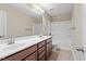 Bathroom with double sink vanity, modern lighting, and a combined tub and shower at 724 Piermont Dr, Cary, NC 27519