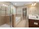Well-lit bathroom featuring a walk-in shower, soaker tub, and double sinks at 724 Piermont Dr, Cary, NC 27519