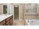 Bathroom with a walk-in shower, soaker tub, and vanity with storage at 724 Piermont Dr, Cary, NC 27519