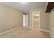 Spacious bedroom with neutral walls, plush carpet, closet, and access to additional rooms at 724 Piermont Dr, Cary, NC 27519