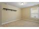 Carpeted bedroom features neutral walls, a dark shelf, and a window at 724 Piermont Dr, Cary, NC 27519