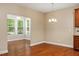 Open dining area with hardwood floors and natural light from adjacent sun room at 724 Piermont Dr, Cary, NC 27519