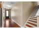 Entrance hallway with hardwood floors, leading to an adjacent staircase, featuring a front door with glass panels at 724 Piermont Dr, Cary, NC 27519