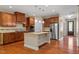 Modern kitchen with stainless steel appliances, granite countertops, an island, and hardwood floors at 724 Piermont Dr, Cary, NC 27519