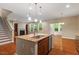 Open-concept living space features fireplace, large windows, hardwood floors, and a granite-topped kitchen island at 724 Piermont Dr, Cary, NC 27519