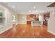 View of an open-concept floorplan where the kitchen flows into the living area with hardwood floors at 724 Piermont Dr, Cary, NC 27519