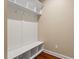 Bright mudroom with white custom storage, seating, and hardwood floors at 724 Piermont Dr, Cary, NC 27519