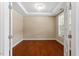 Bright home office featuring hardwood floors, a tray ceiling, and natural light streaming through a large window at 724 Piermont Dr, Cary, NC 27519