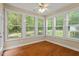 Bright sun room with hardwood floors and lots of natural light from large windows overlooking backyard at 724 Piermont Dr, Cary, NC 27519