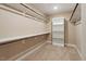 Carpeted walk-in closet with ample shelving and hanging storage at 724 Piermont Dr, Cary, NC 27519