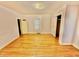 Bedroom with hardwood floors, base trim, and standard closets with simple window at 747 Buckhorn Rd, Sanford, NC 27330