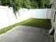 A cozy backyard area featuring a concrete patio and a white privacy fence at 820 Houston Ct, Haw River, NC 27258