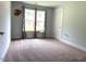 This bedroom features neutral walls, plush carpeting and a window overlooking the front yard at 820 Houston Ct, Haw River, NC 27258