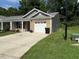 Charming single-story home with a brick facade, white garage door, and well-maintained landscaping at 820 Houston Ct, Haw River, NC 27258