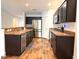 Well-lit kitchen boasts stainless steel appliances, dark cabinets, and ample counter space at 820 Houston Ct, Haw River, NC 27258